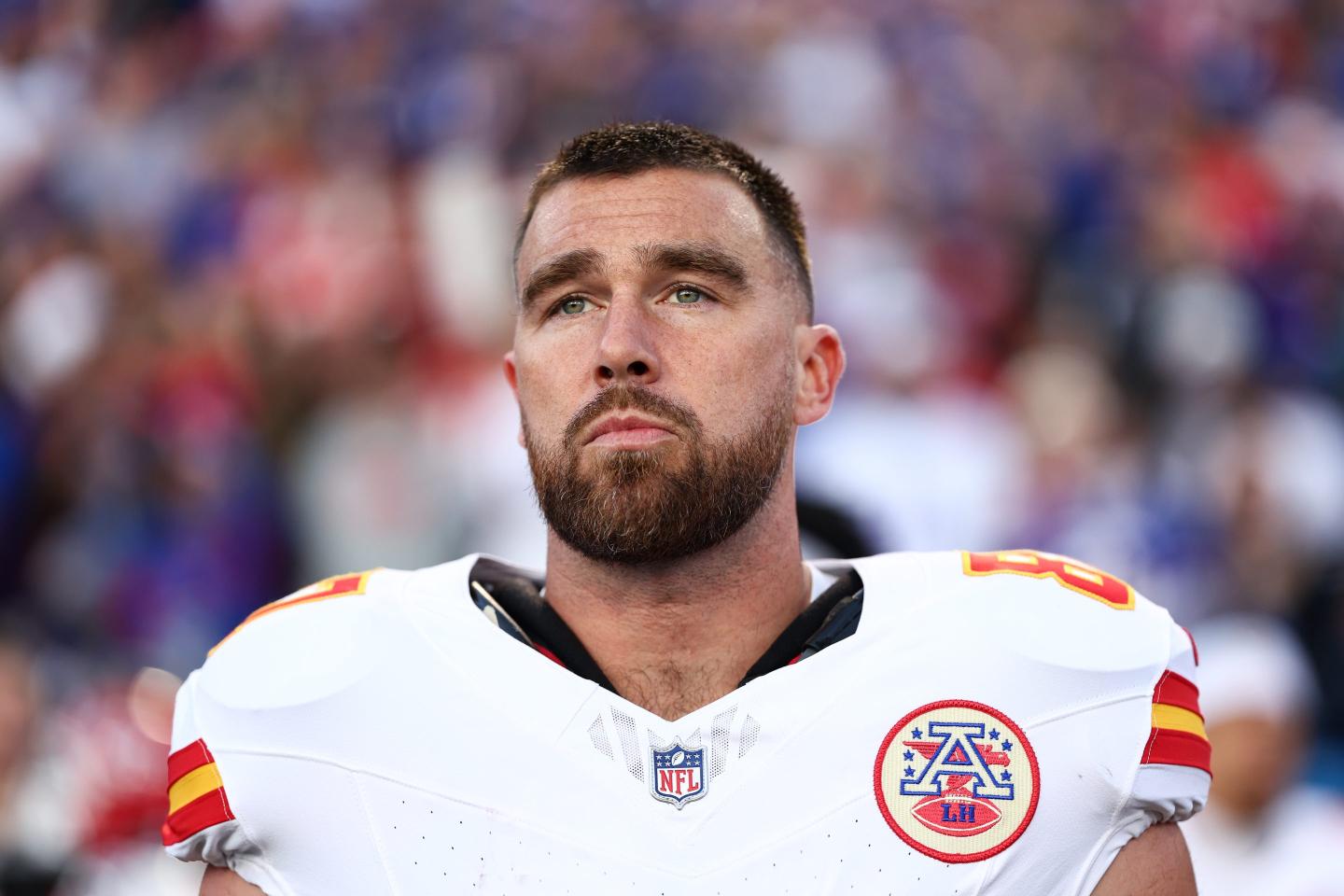 Travis Kelce #87 of the Kansas City Chiefs stands on the sideline during the national anthem prior to the game against the Buffalo Bills at Highmark Stadium.