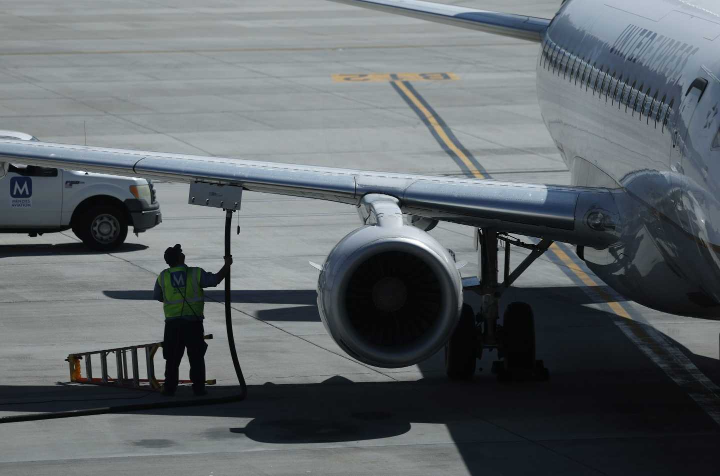A worker fuels a United Airlines plane at Salt Lake City International Airport.