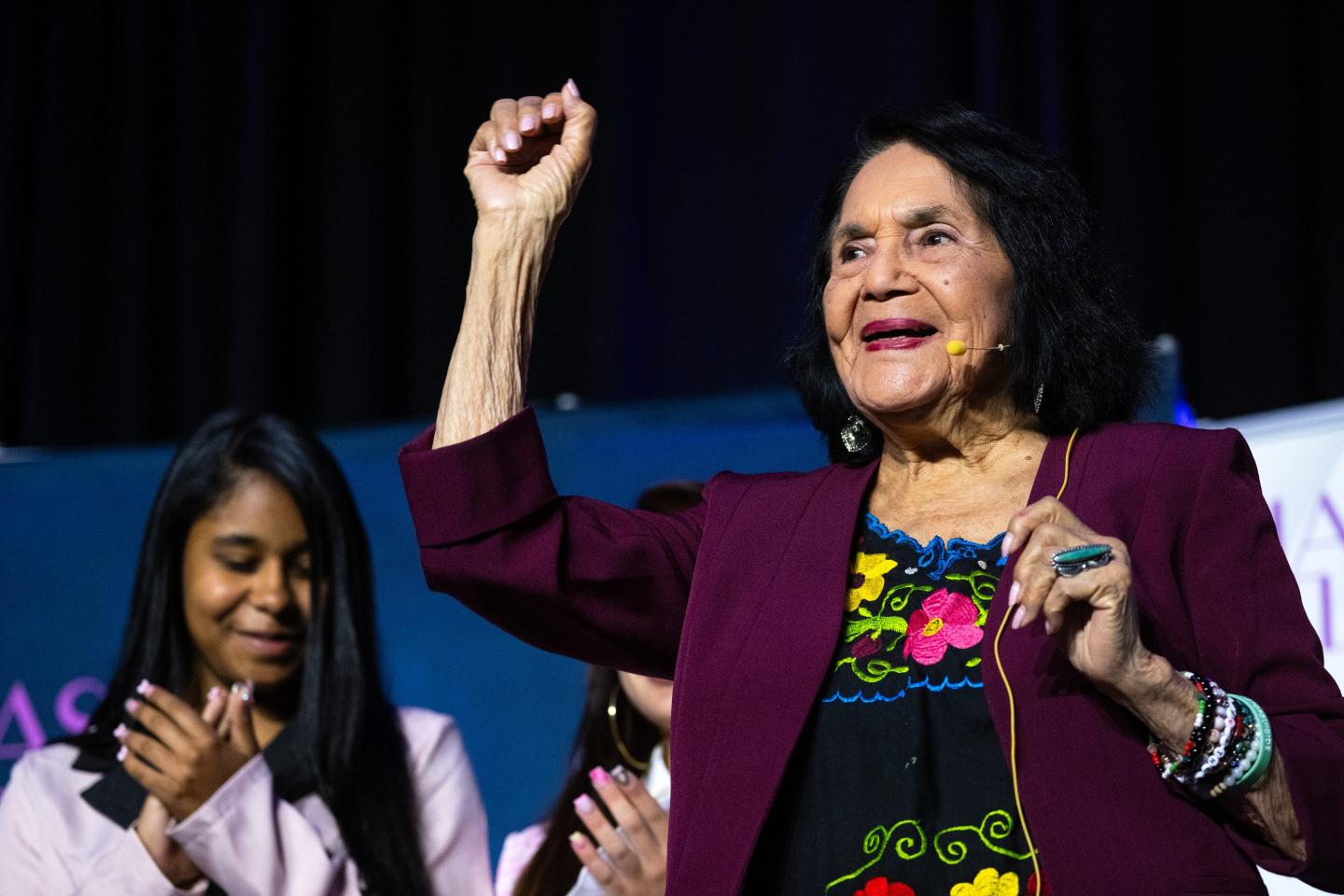 Dolores Huerta leads the crowd in a chant after an on-stage discussion with Connecticut Public's Rachel Iacovone and Latinas in Leadership founder and CEO Marilyn Alverio at the Latinas in Leadership Symposium at the Connecticut Convention Center in Hartford, Connecticut on May 28, 2026.