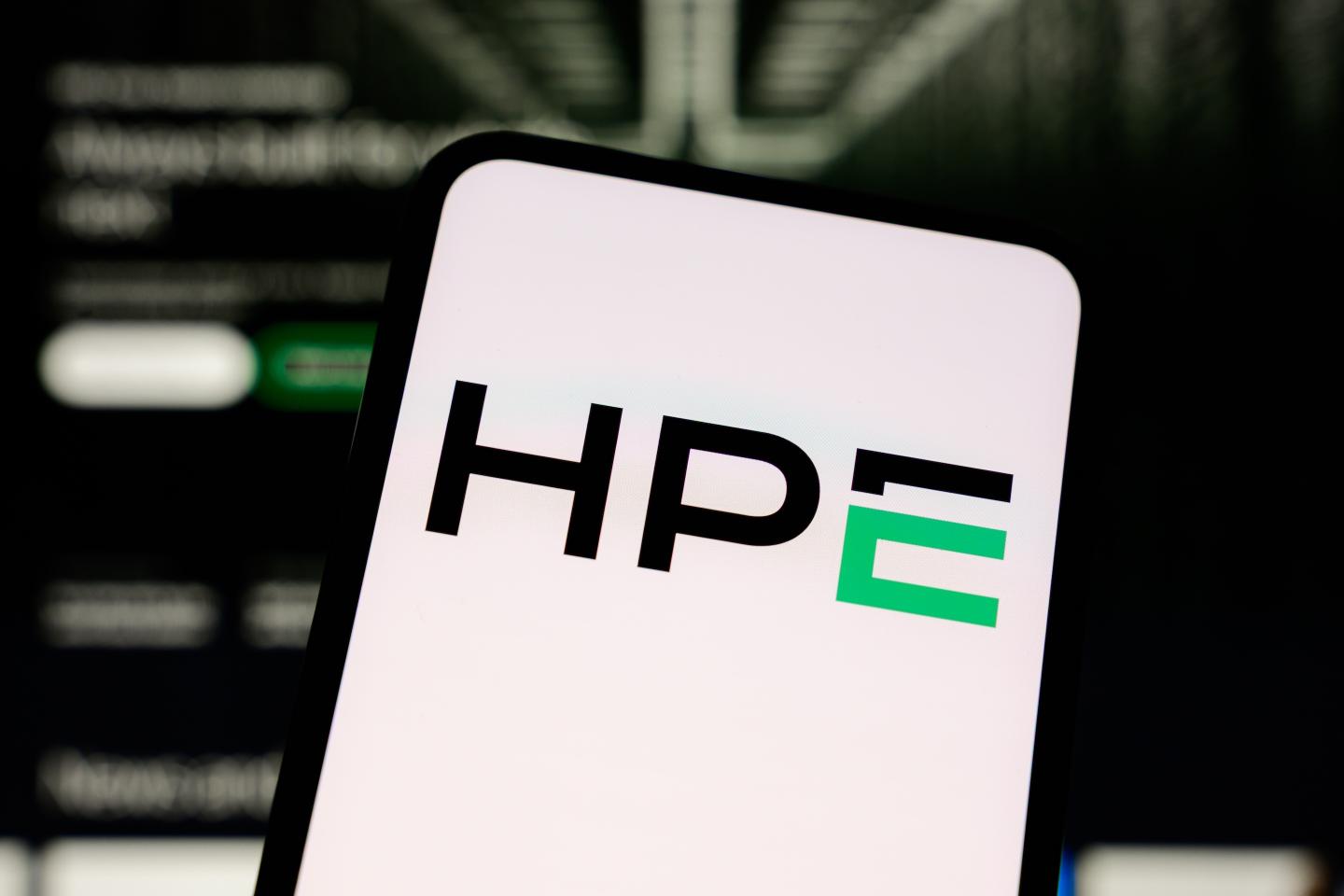 The Hewlett Packard Enterprise (HPE) logo is displayed on a smartphone screen with the company's website in the background.