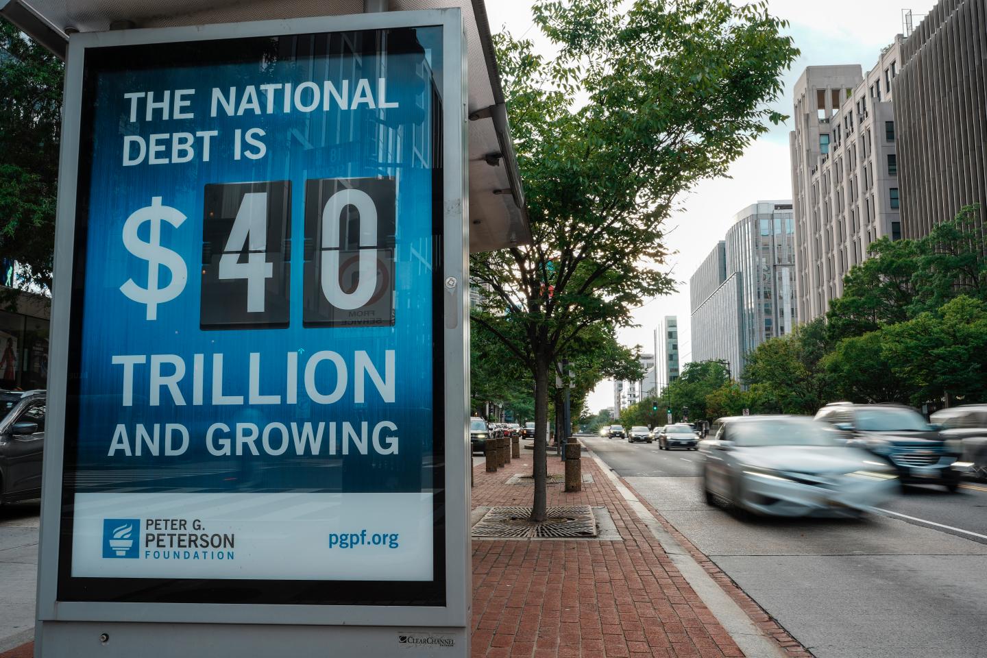A view of a bus shelter at 18th and K St's NW where a poster and electronic billboard displays the current U.S. National debt per person and as a nation at 40 Trillion dollars on August 30, 2026 in Washington, DC.