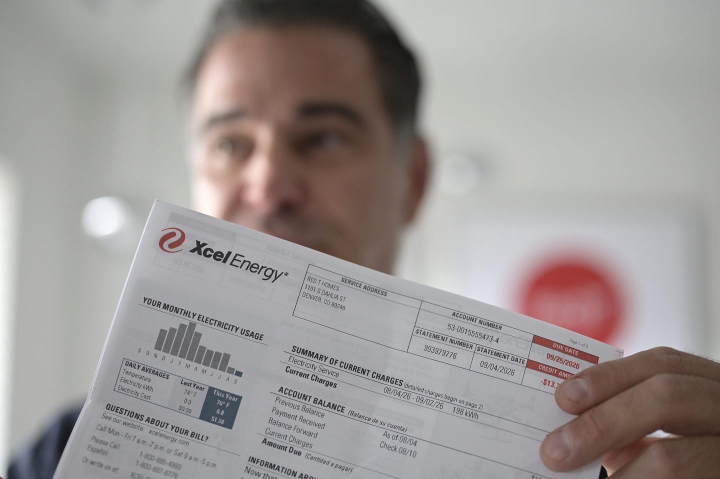 Nathan Adams, CEO of redT Homes, shows an Excel Energy bill at his office in Denver, Colorado on Thursday, Sept. 17, 2026.