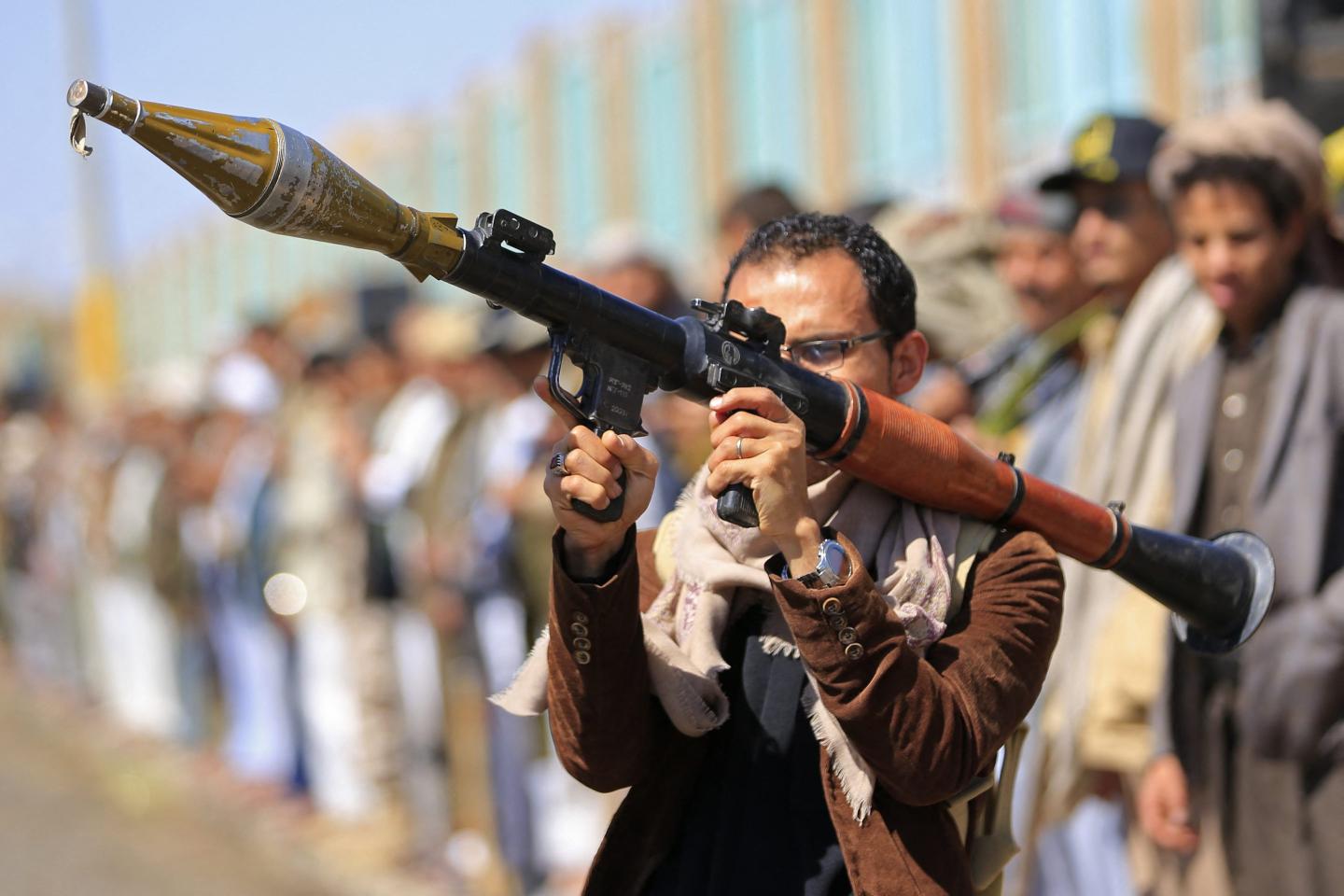A fighter loyal to the Houthi authorities, brandishes his weapon during a rally to recruit more fighters, in Sanaa on Oct. 7, 2026. 