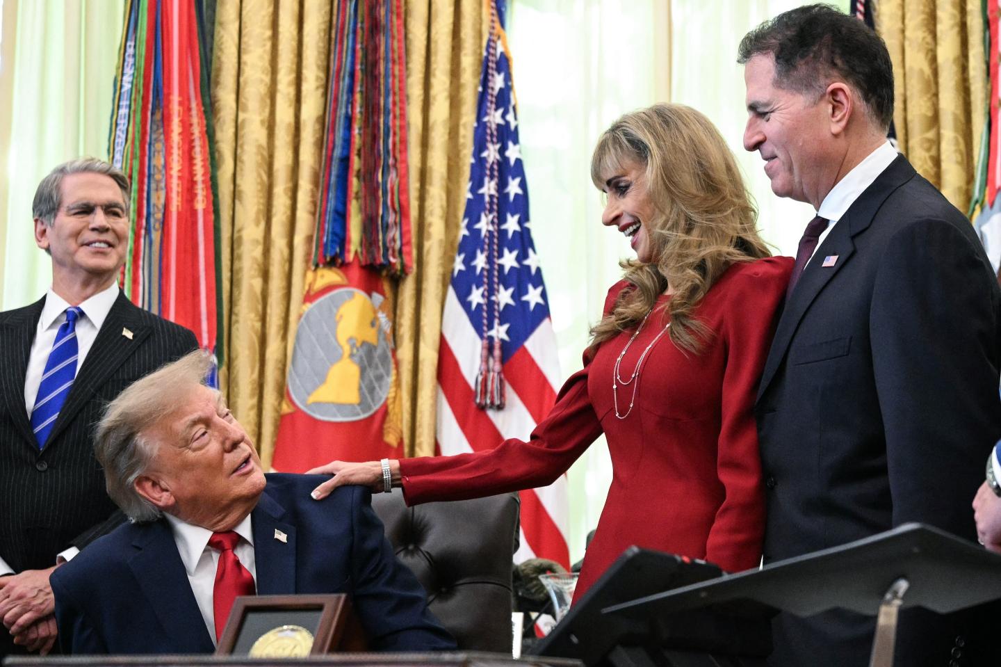 US President Donald Trump, alongside Secretary of Treasury Scott Bessent (L), Susan Dell (2R), and Michael Dell (R), speaks about "Trump accounts," investment savings accounts for children, in the Oval Office in the White House in Washington, DC on October 7, 2026. 