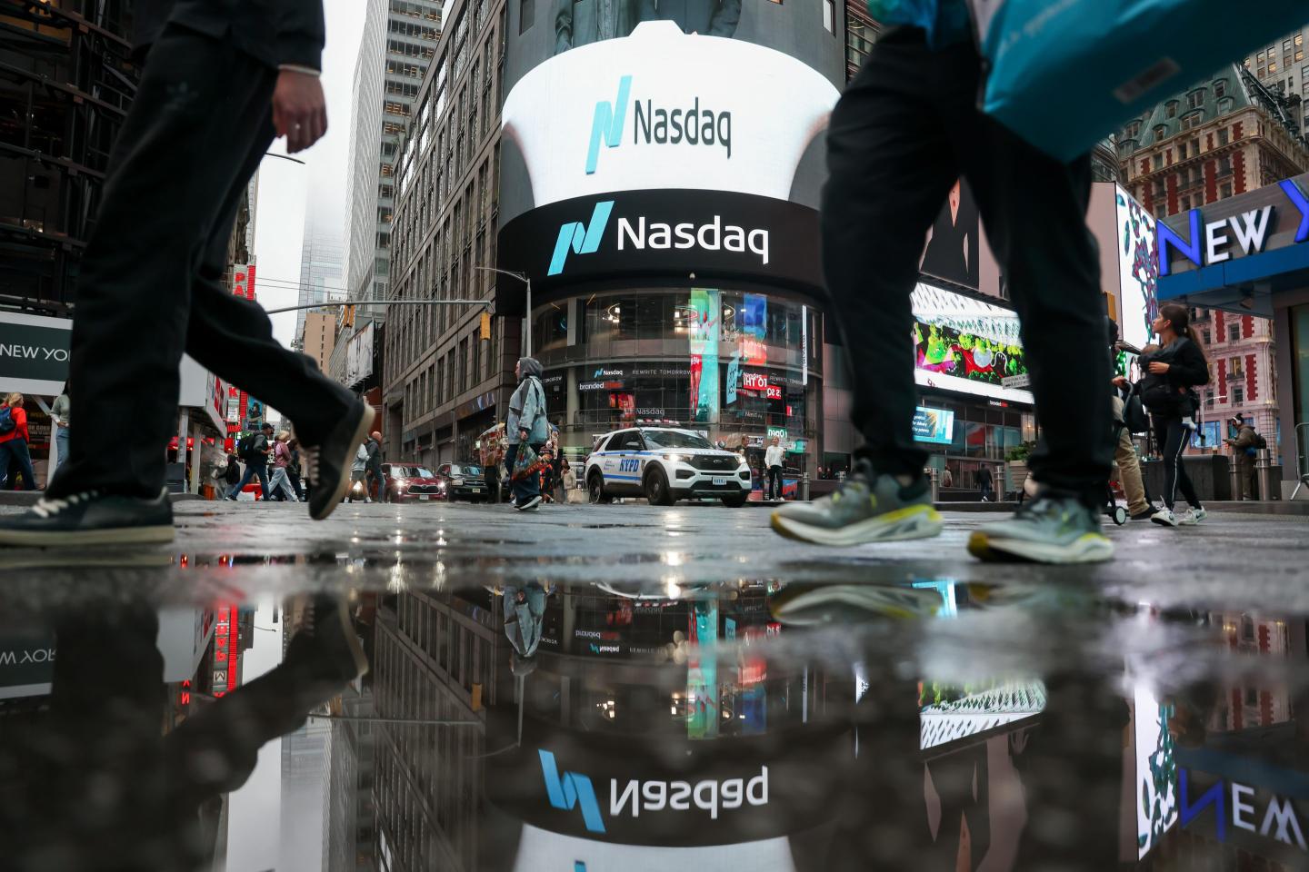 Pedestrians outside the Nasdaq MarketSite in New York, on Oct. 16, 2026. 