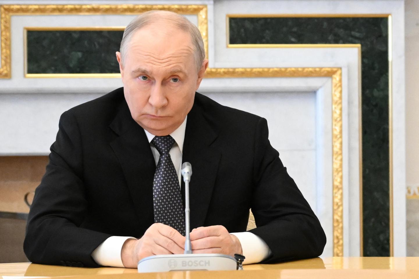 In this pool photograph distributed by the Russian state agency Sputnik, Russia's President Vladimir Putin attends a meeting with US special envoy in Saint Petersburg.