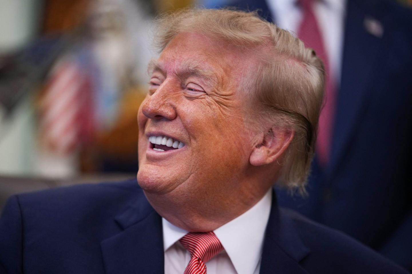 U.S. President Donald Trump reacts during an event in the Oval Office of the White House.