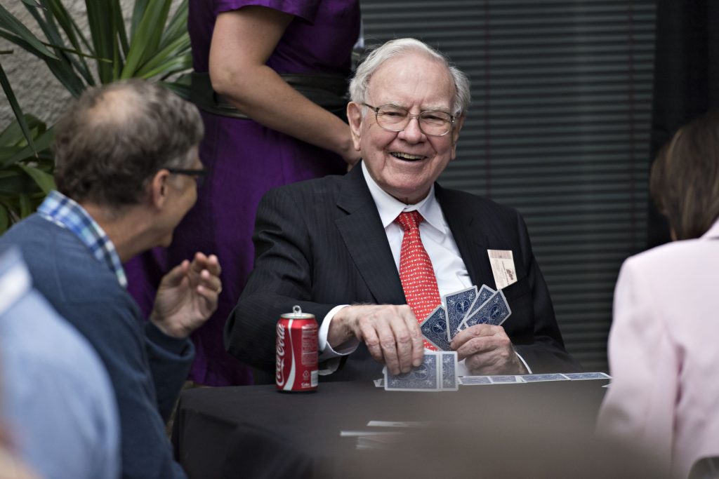 Warren Buffett laughs with Bill Gates as they play bridge