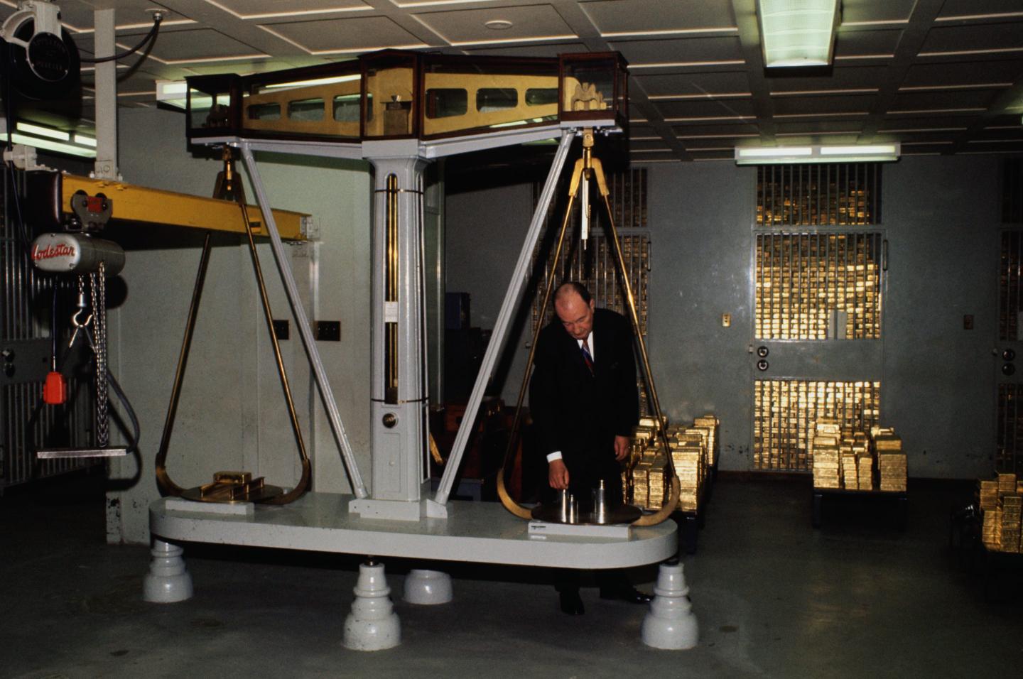 Gold bars are weighed on a giant scale in the gold vault of the Federal Reserve Bank.