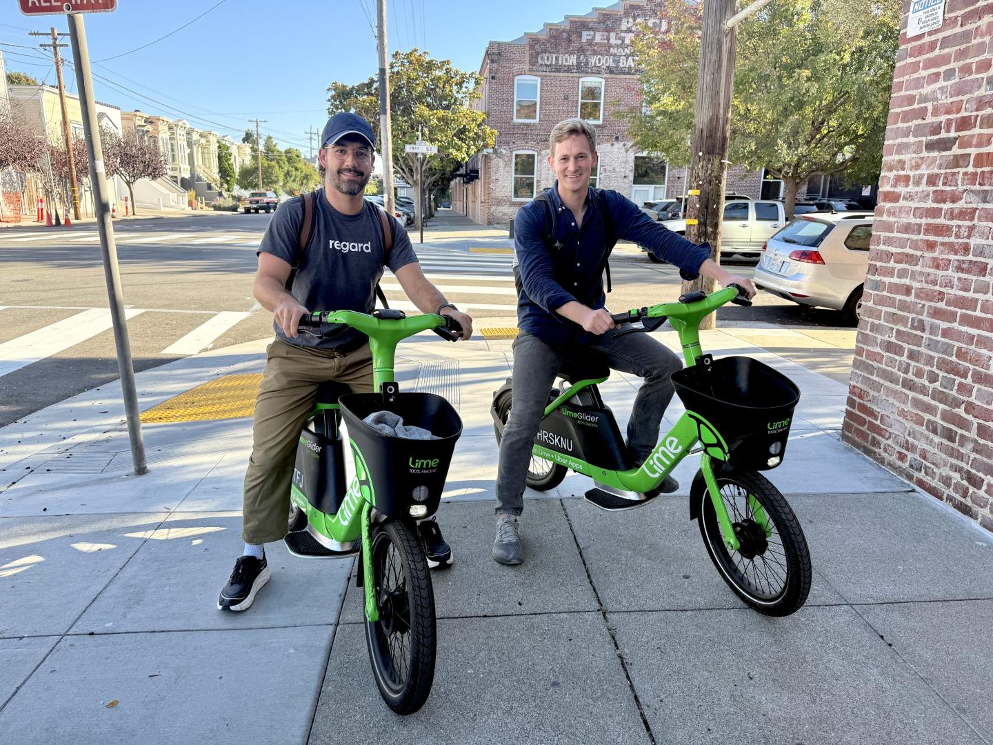 Cofounders Nate Wilson and Eli Ben-Johnson sit on robobikes.