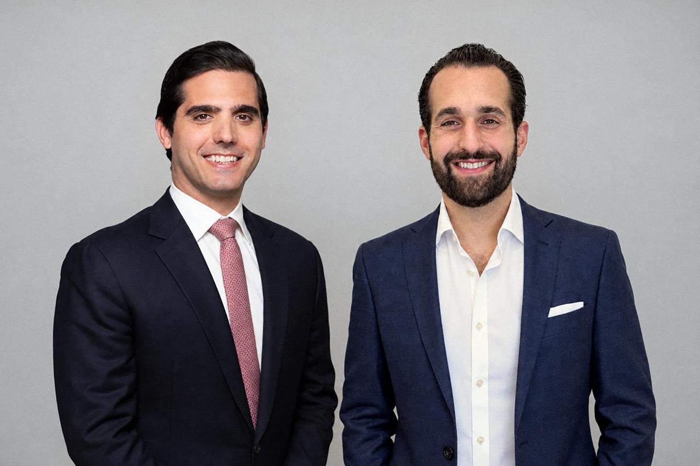 Jonathan Shaffer (left) and Steve Bendit (right) wear suits and smile at the camera against a grey backdrop.
